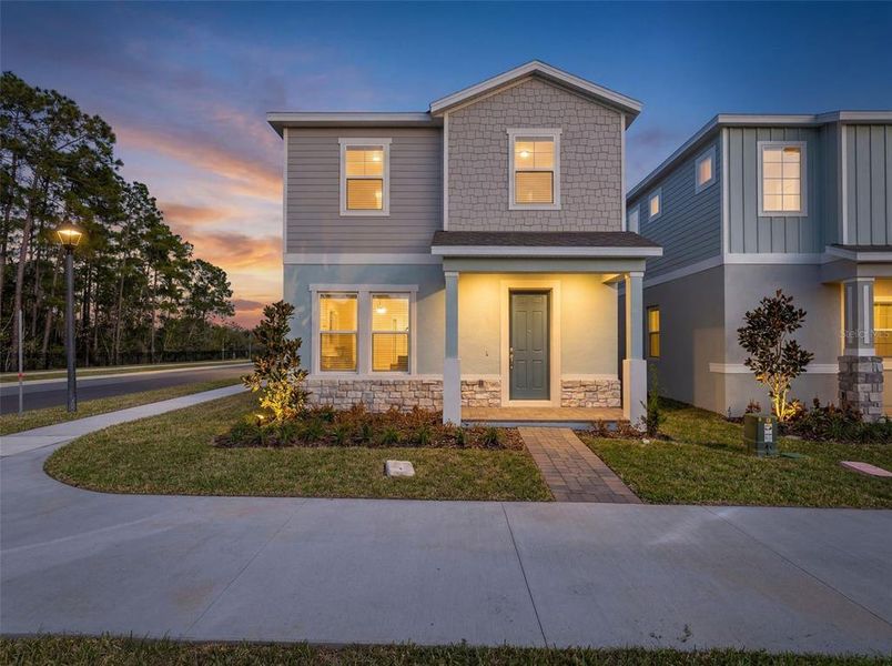 Front exterior of a new home in Serenade at Ovation, Winter Garden, FL, highlighting curb appeal (Image 19).