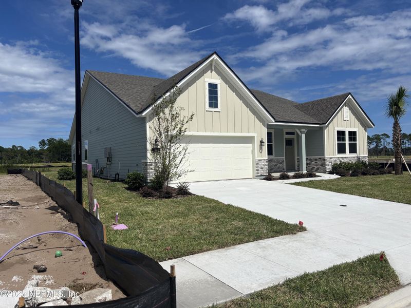 Front exterior of a new home in The Cypress Series at Reserve East, Flagler Beach, FL, highlighting curb appeal (Image 16).