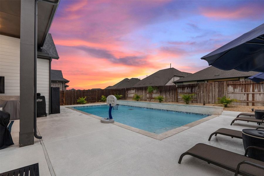 Enjoy a resort-style backyard with heated pool, covered patio, and professional landscaping. Enjoy a resort-style backyard with heated pool, covered patio, and professional landscaping.