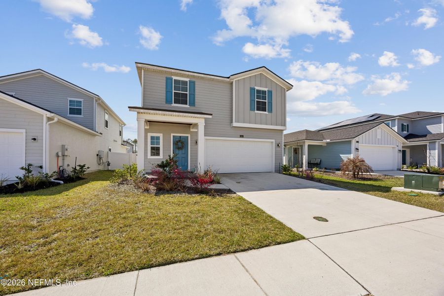 Front exterior of a new home in Cordova Palms, St. Augustine, FL, highlighting curb appeal (Image 22).