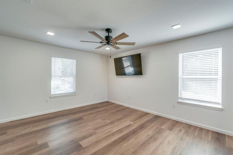 Unfurnished room featuring ceiling fan and light hardwood / wood-style floors