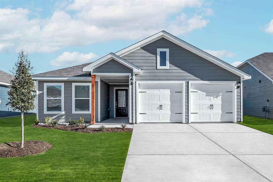 View of front of home featuring a garage and a front lawn