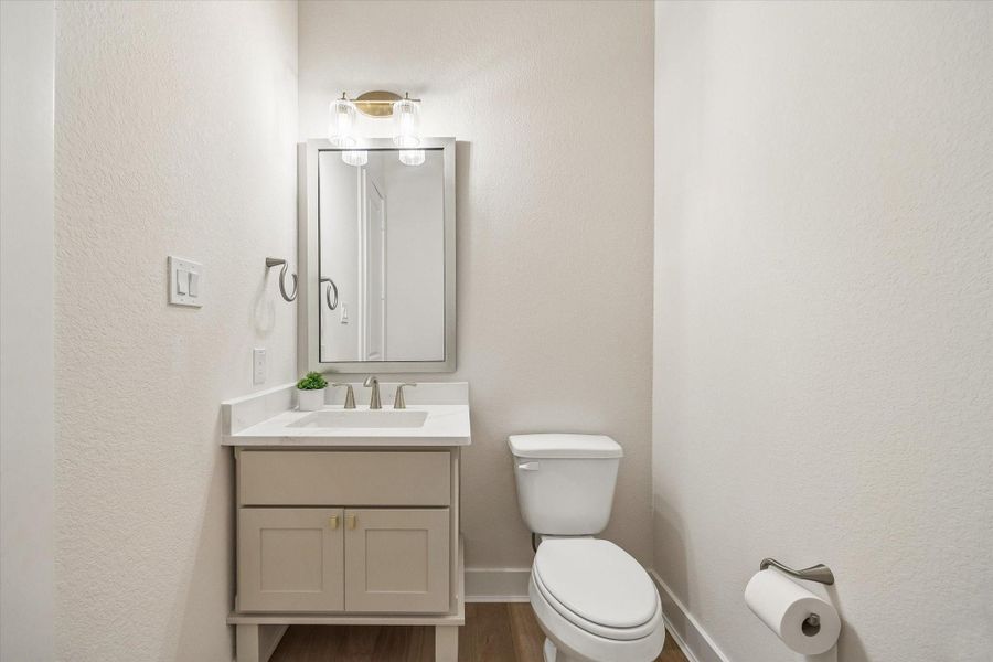 ONE OF TWO POWDER BATHROOMS, THIS ONE OFFERS A SINGLE VANITY WITH QUARTZ COUNTERTOPS, A FRAMED MIRROR, AND CONTEMPORARY FIXTURES. ONE OF TWO POWDER BATHROOMS, THIS ONE OFFERS A SINGLE VANITY WITH QUARTZ COUNTERTOPS, A FRAMED MIRROR, AND CONTEMPORARY FIXTURES.
