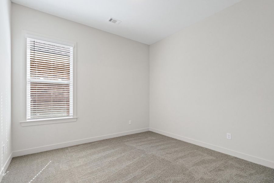 Empty room with baseboards and light colored carpet