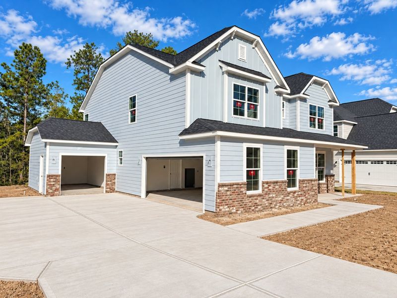 Front exterior of a new home in Arbordale Reserve, Elgin, SC, highlighting curb appeal (Image 2).