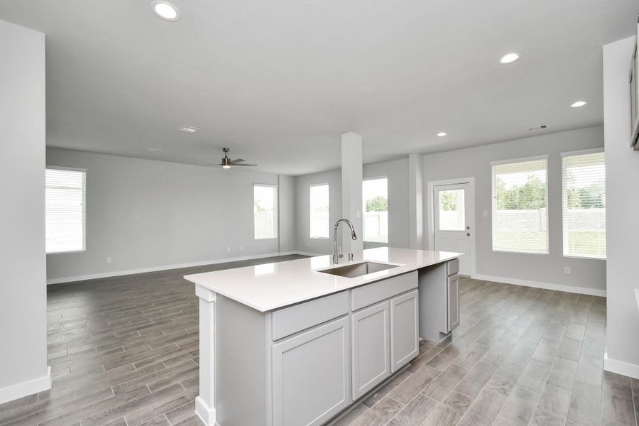 All of this overlooks your expansive family room, creating a perfect space for culinary delights and family gatherings. Sample photo of completed home with similar floor plan. Actual colors and selections may vary.