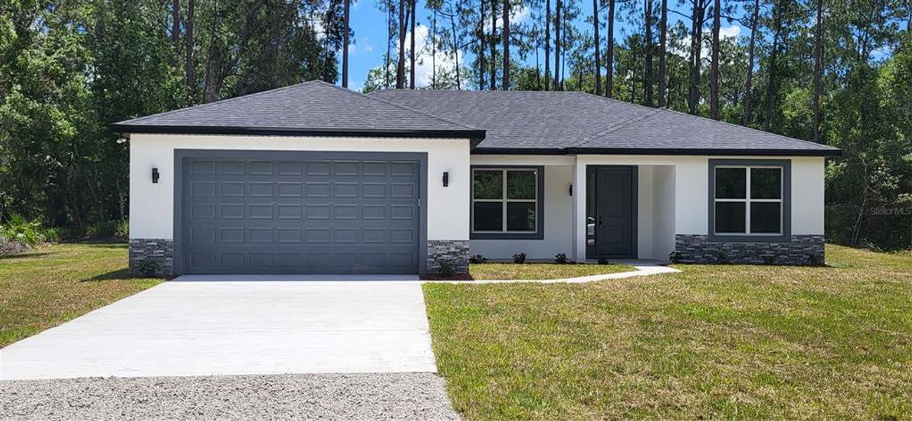 Front exterior of a new home in , Bunnell, FL, highlighting curb appeal (Image 1). Front exterior of a new home in , Bunnell, FL, highlighting curb appeal (Image 1).