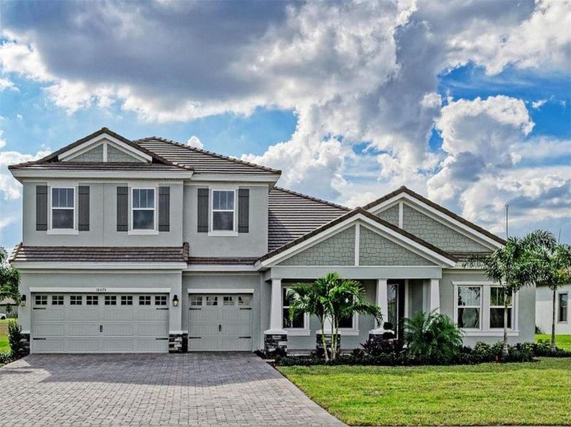 Front exterior of a new home in Creek Ridge Preserve, Lithia, FL, highlighting curb appeal (Image 1).