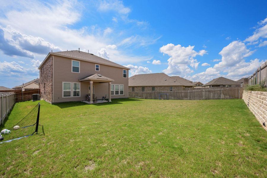 Back of house featuring a fenced backyard, a patio, and a residential view Back of house featuring a fenced backyard, a patio, and a residential view