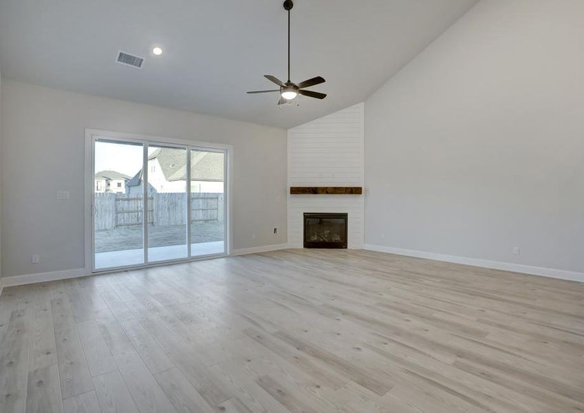 Spacious living room with a fireplace, creating the perfect spot to lounge.