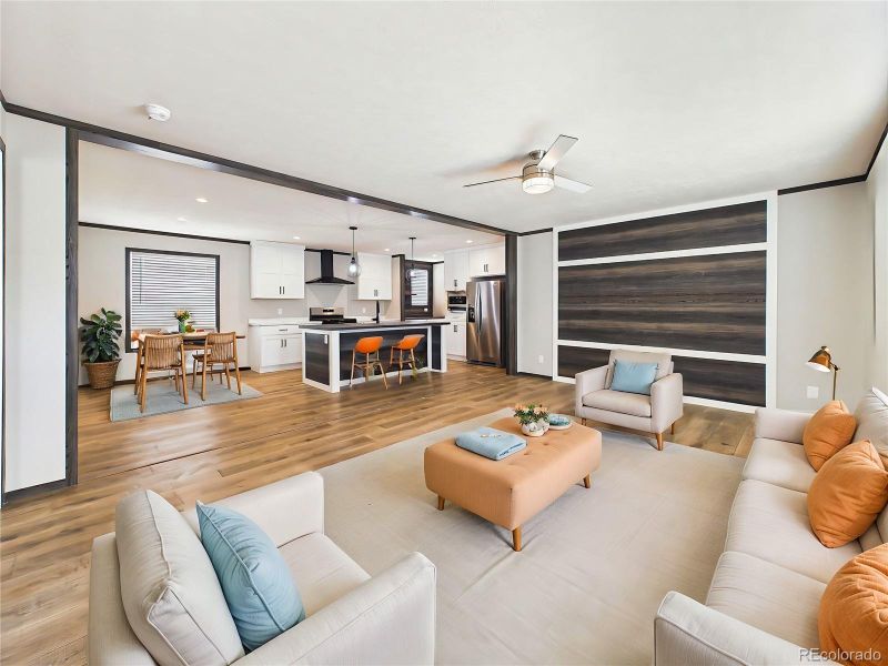 (Virtually Staged) Open living space showcasing clean lines, Luxury Vinyl flooring, and a striking accent wall, offering flexibility for furniture placement.