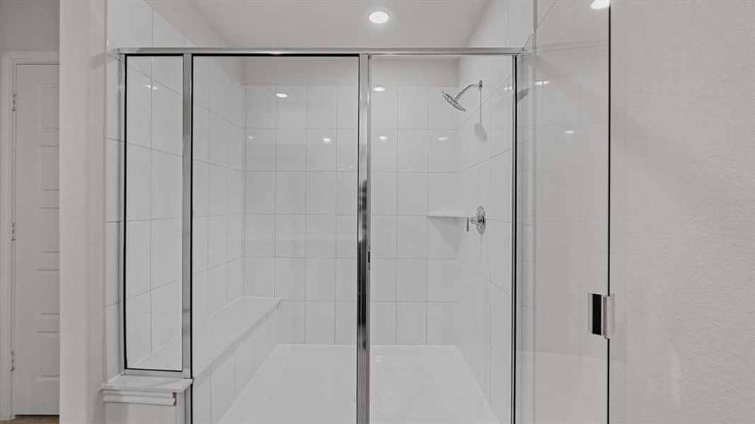 Walk-in shower with clear glass enclosure and chrome hardware Walk-in shower with clear glass enclosure and chrome hardware
