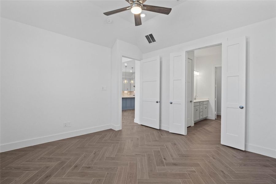 Additional view from primary bedroom looking towards the double door entrance to primary bathroom.