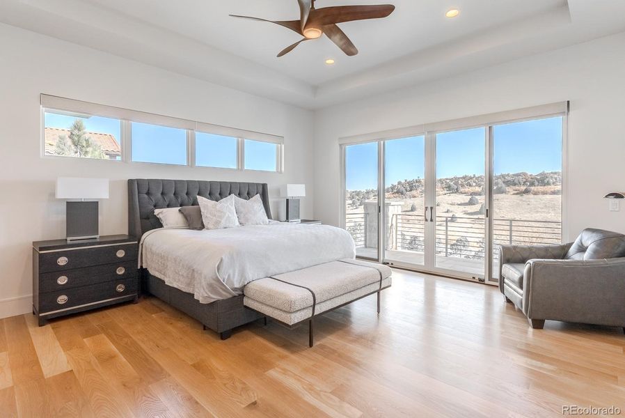 A sanctuary of calm, the primary suite opens directly to the upper terrace and its sweeping golf-course and red-rock views.