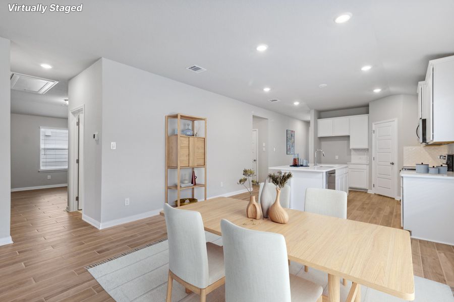 Virtually staged dining room and kitchen in the Allen floorplan at a Meritage Homes community. Virtually staged dining room and kitchen in the Allen floorplan at a Meritage Homes community.