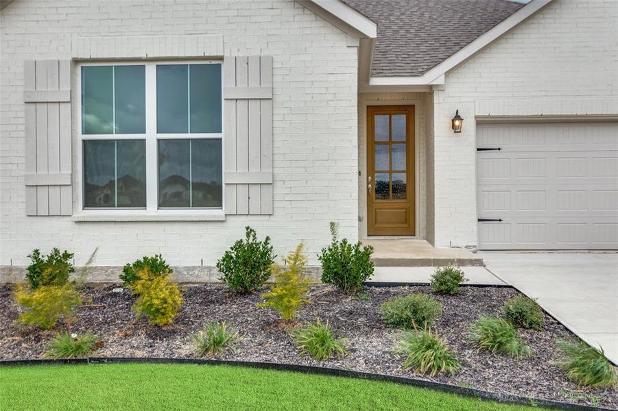 View of exterior entry with a garage