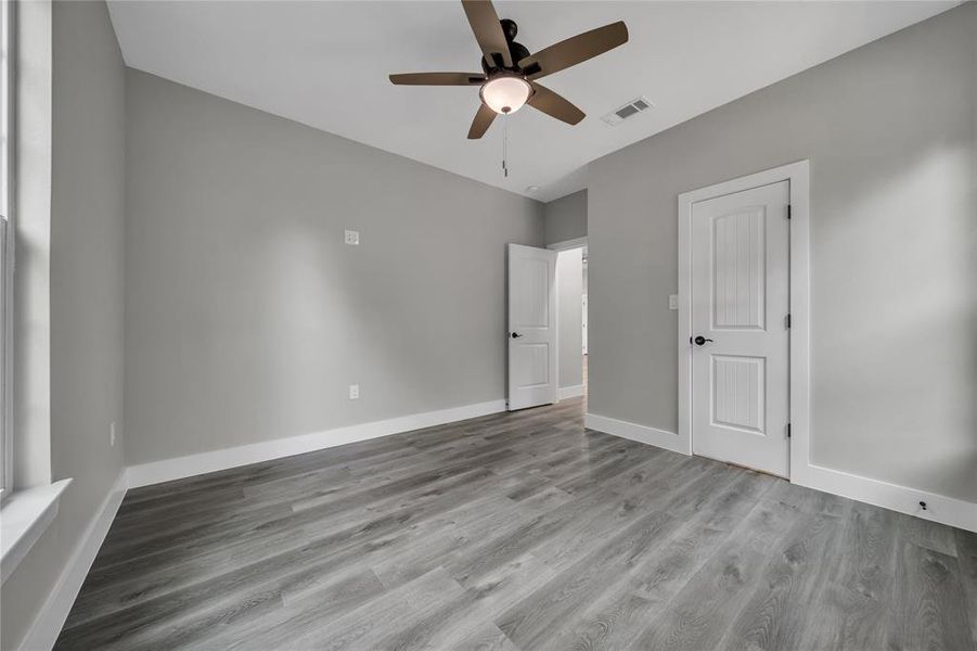 Empty room featuring ceiling fan and hardwood / wood-style floors