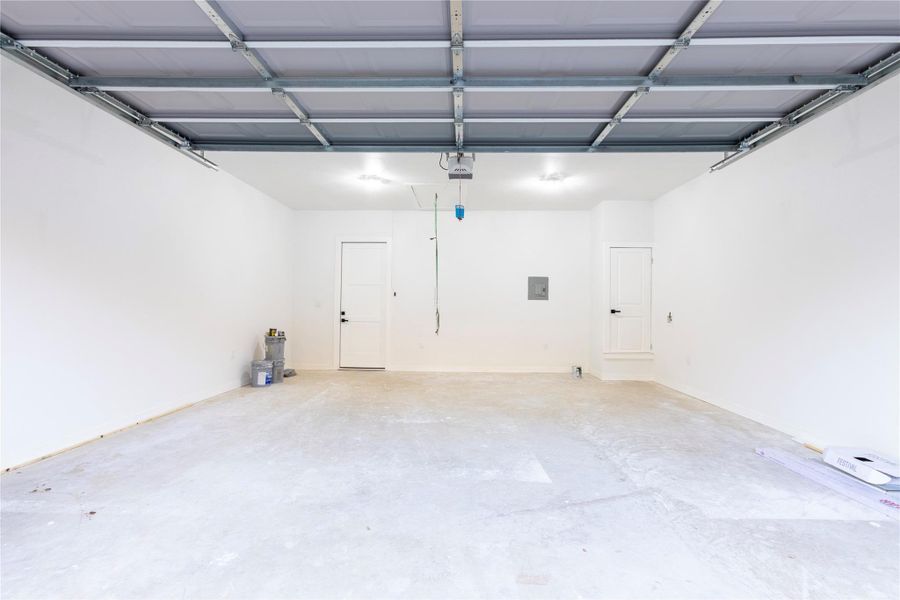 Spacious garage featuring abundant storage options.