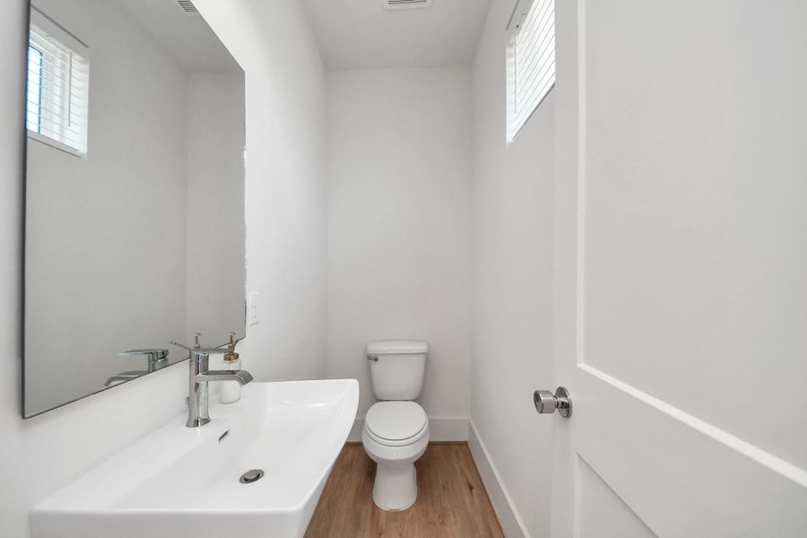 This powder room exudes charm; it blends classic with a touch of modern design. This powder room exudes charm; it blends classic with a touch of modern design.