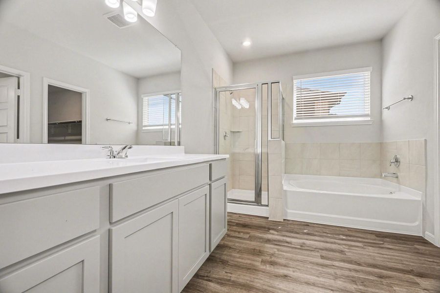 Dual vanity layout with generous storage and wide mirror for added functionality. Dual vanity layout with generous storage and wide mirror for added functionality.