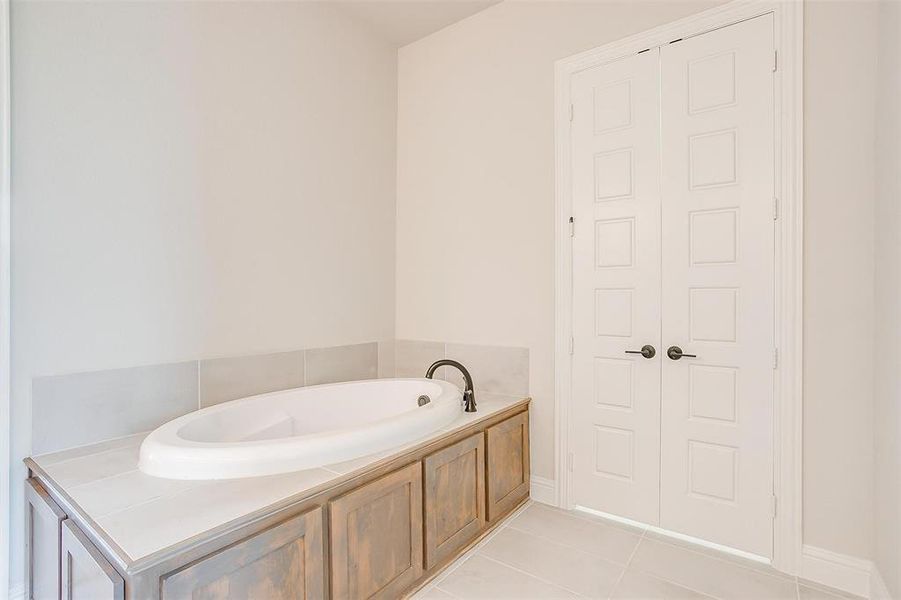 Bathroom featuring a bathtub and tile patterned floors