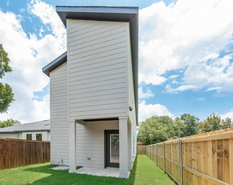 Rear view of house featuring a fenced backyard and a patio area Rear view of house featuring a fenced backyard and a patio area