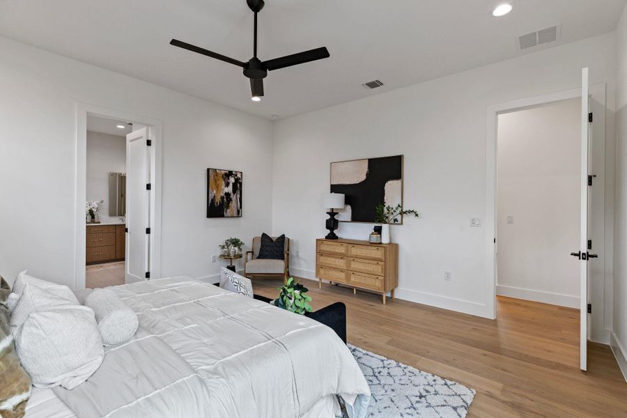 Bedroom featuring light wood-style floors, baseboards, recessed lighting, ceiling fan, and connected bathroom
