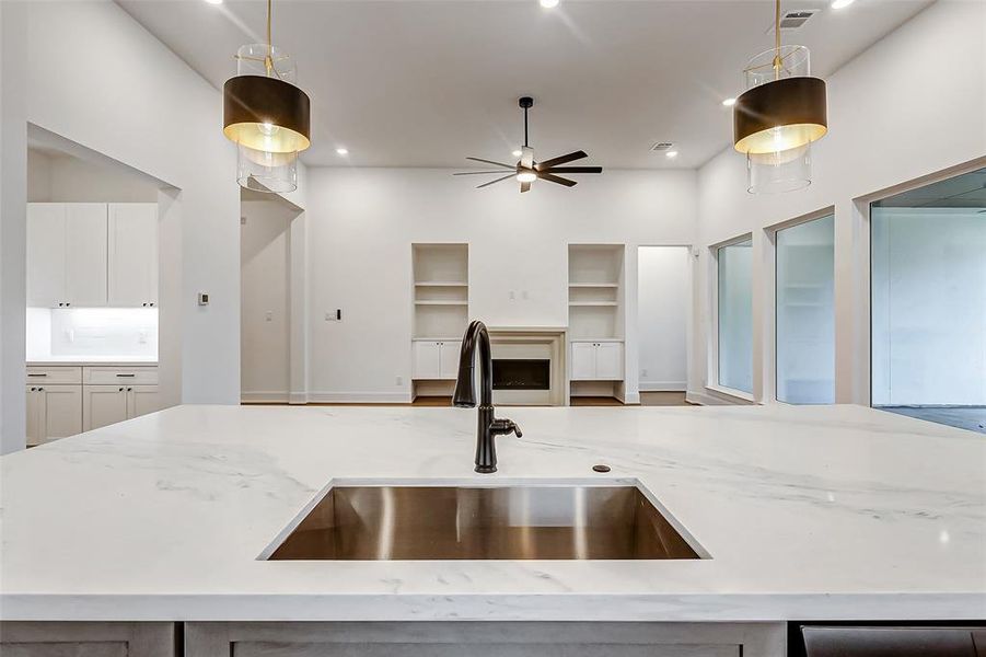 The oversized sink with an oil rubbed bronze faucet overlooks the family room for an all-inclusive feel.