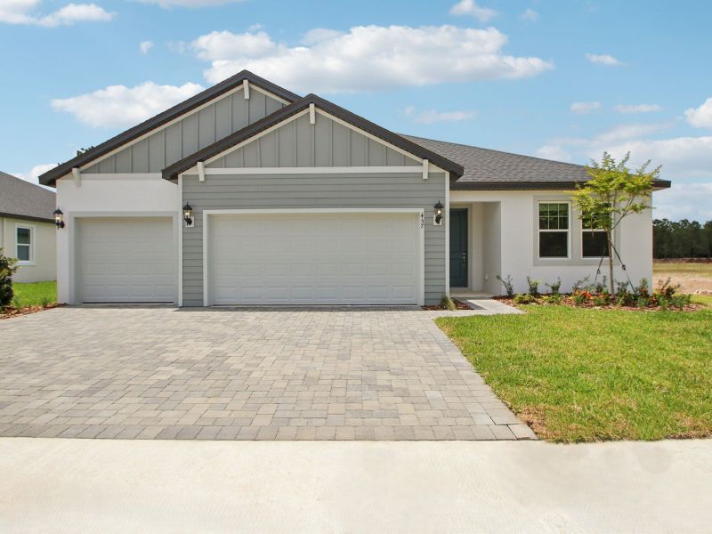 Front exterior of a new home in Ridgehaven - Reserve Series, Ormond Beach, FL, highlighting curb appeal (Image 1).