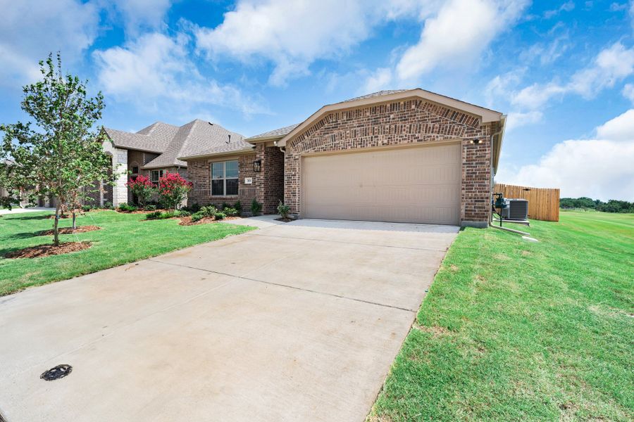 Front exterior of a new home in Fox Landing, Caddo Mills, TX, highlighting curb appeal (Image 19). Front exterior of a new home in Fox Landing, Caddo Mills, TX, highlighting curb appeal (Image 19).
