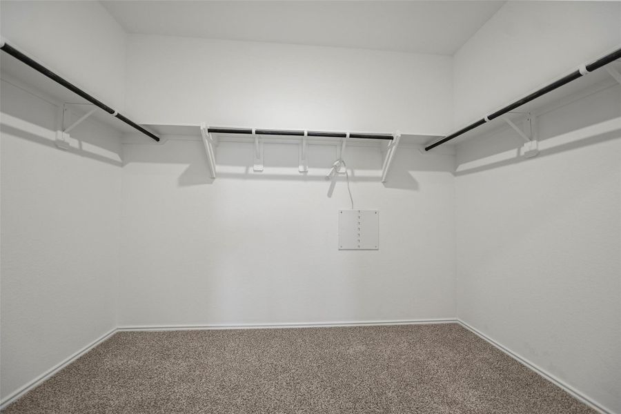 Spacious walk-in closet with built-in shelving Spacious walk-in closet with built-in shelving