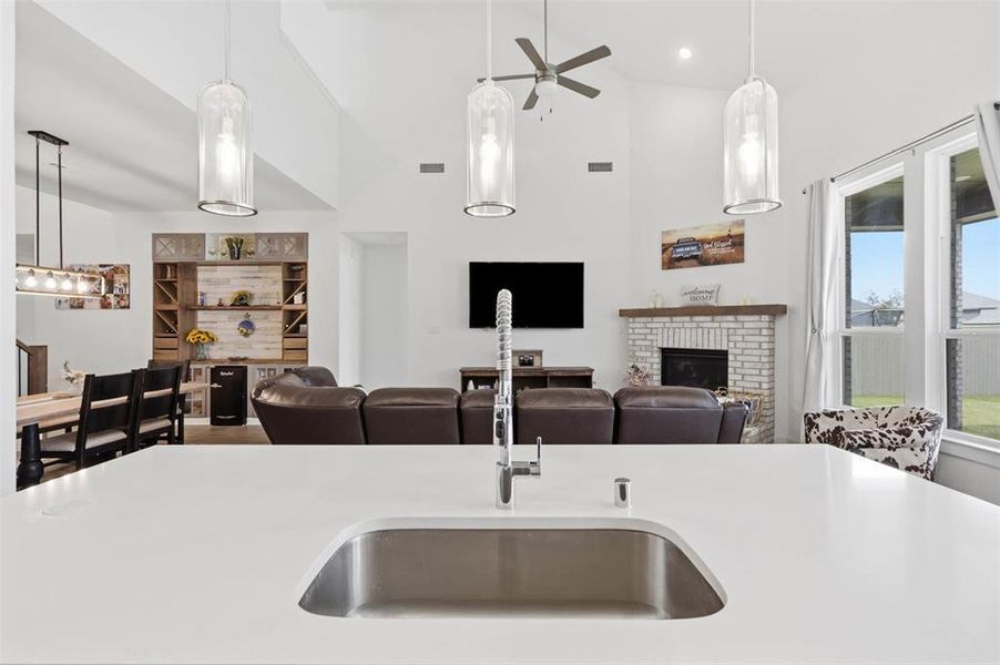 Kitchen island with a stainless steel undermount sink and gooseneck faucet