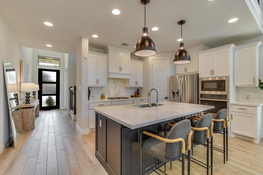 Kitchen is an open floor plan with stainless steel appliances.