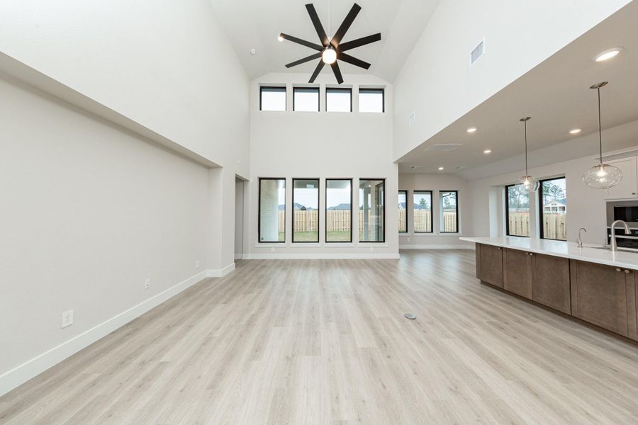 Enjoy an open, airy living experience in the GREAT ROOM where oversized windows flood the entire space with abundant natural light and frame a picturesque view of the serene backyard. A large ceiling fan provides comfort all year long. The integrated wall niche offers valuable recessed storage and display space without encroaching on the room's floor plan.