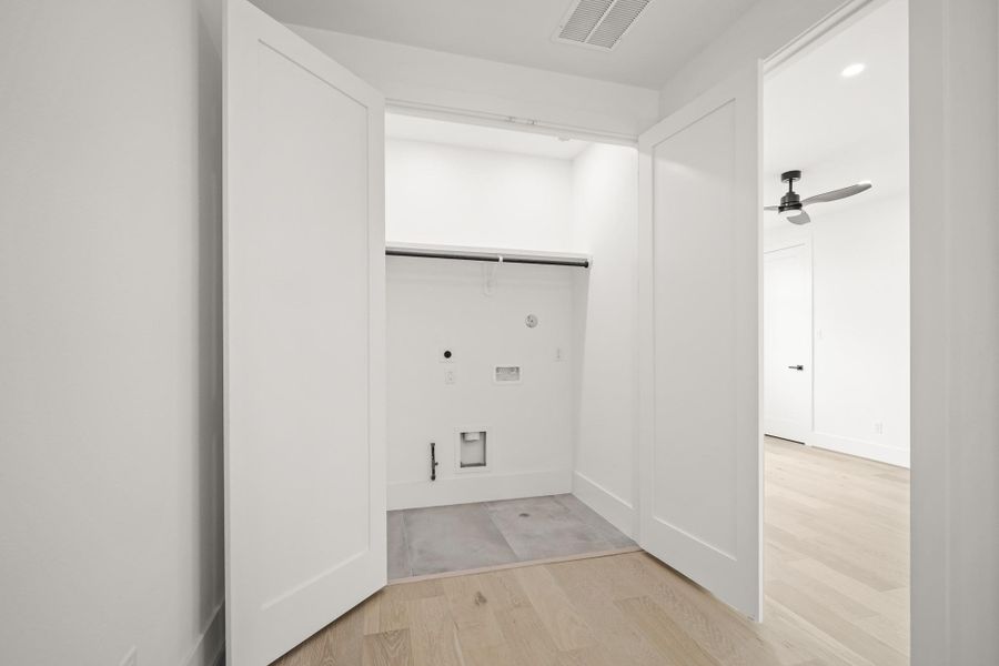 Conveniently located within the third floor corridor is the laundry room with upper shelf and hanging rods. There is plenty of room for a full size washer and dryer with electric or gas connections.