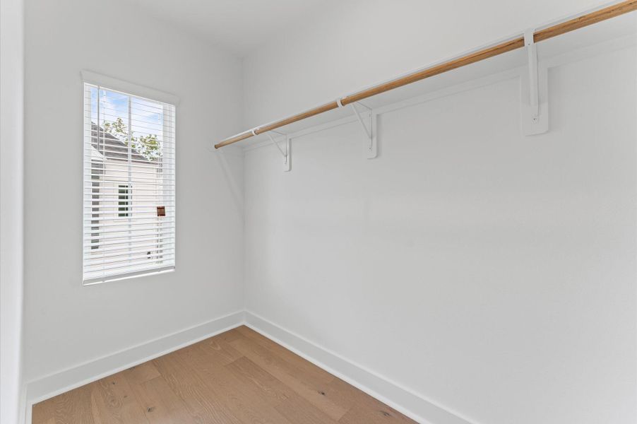 This spacious primary bedroom offers a luxurious retreat, complete with two generously sized closets designed for optimal organization and convenience.