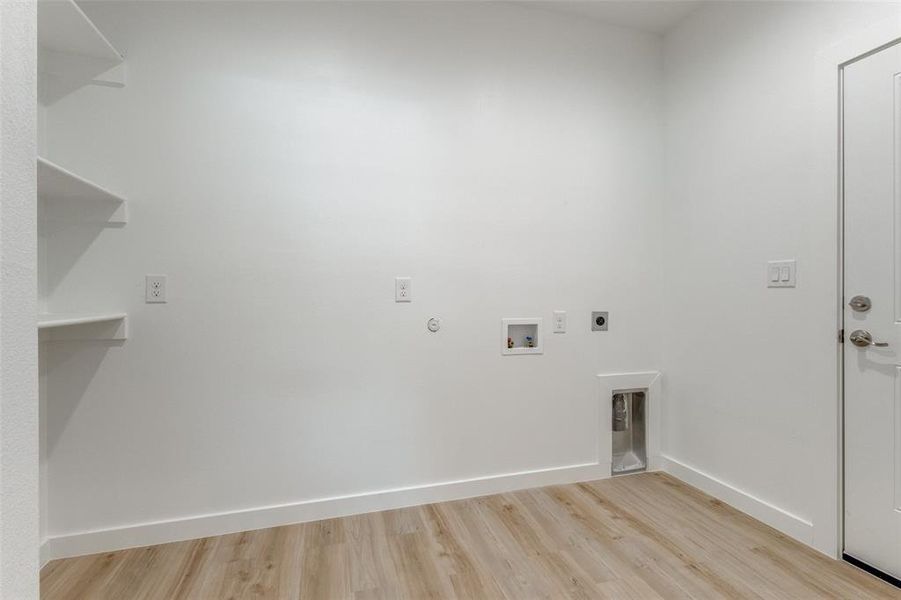 Laundry area featuring light hardwood / wood-style flooring, hookup for a washing machine, and hookup for an electric dryer