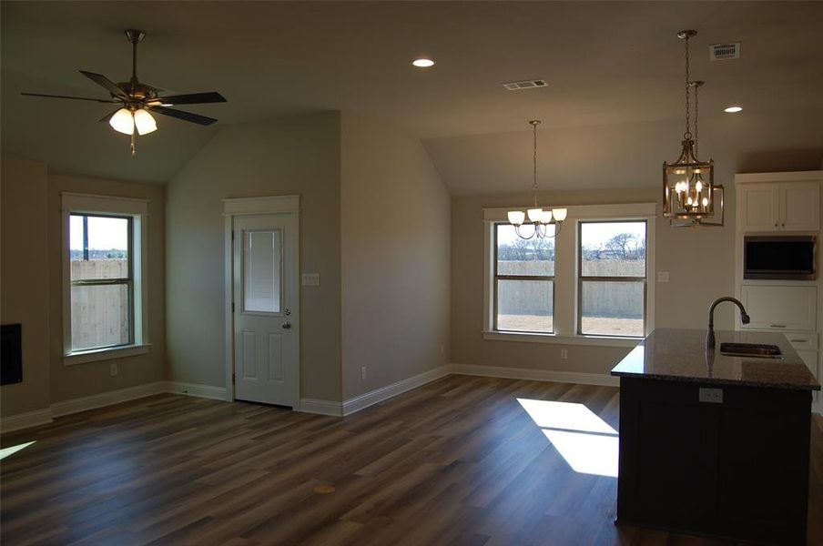 Kitchen with a wealth of natural light, dark wood-type flooring, and sink