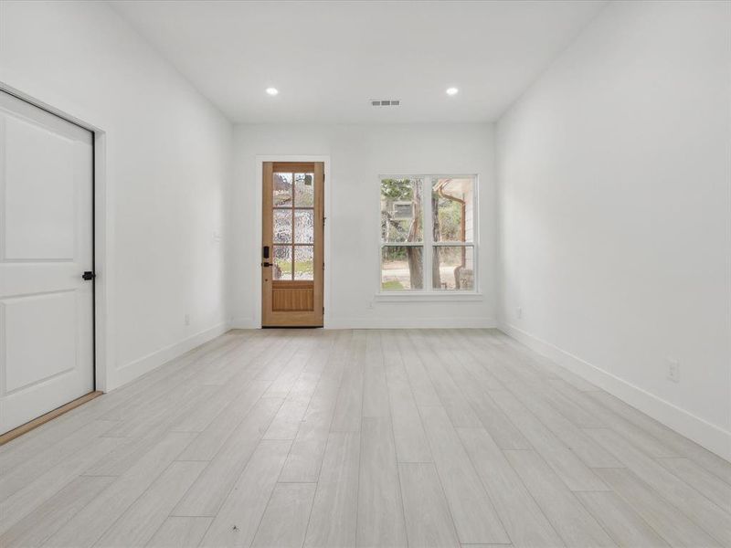 Unfurnished room with light wood-type flooring