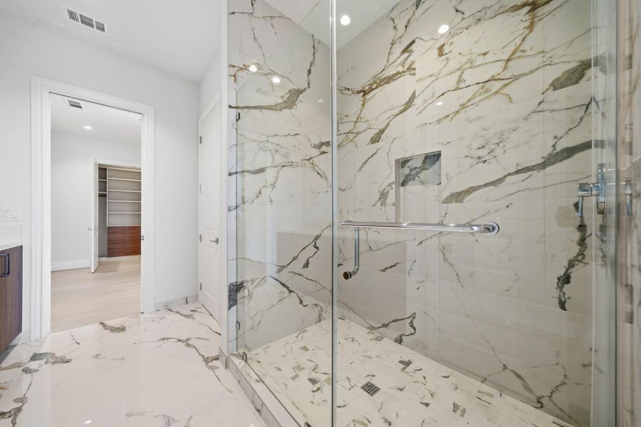 Hollywood Bath: A true standout, the shower is clad in dramatic marble, seamless glass shower and double sinks. Hollywood Bath: A true standout, the shower is clad in dramatic marble, seamless glass shower and double sinks.