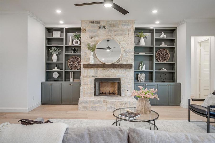 Living room with beautiful hardwood floors and 10 ft ceilings, fireplace with stone surround and cedar mantel.