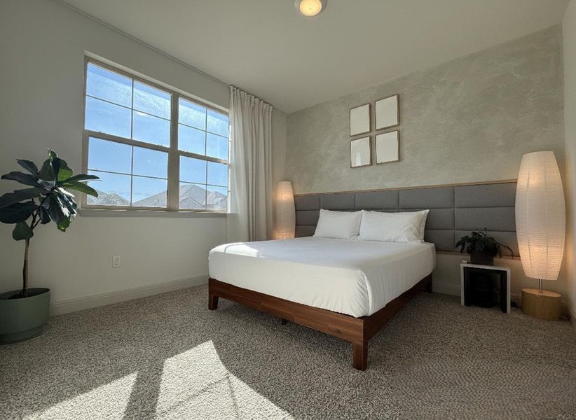 Carpeted bedroom with baseboards