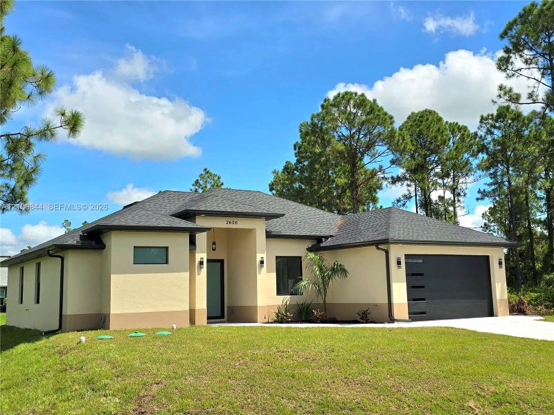 Front exterior of a new home in , Lehigh Acres, FL, highlighting curb appeal (Image 17). Front exterior of a new home in , Lehigh Acres, FL, highlighting curb appeal (Image 17).