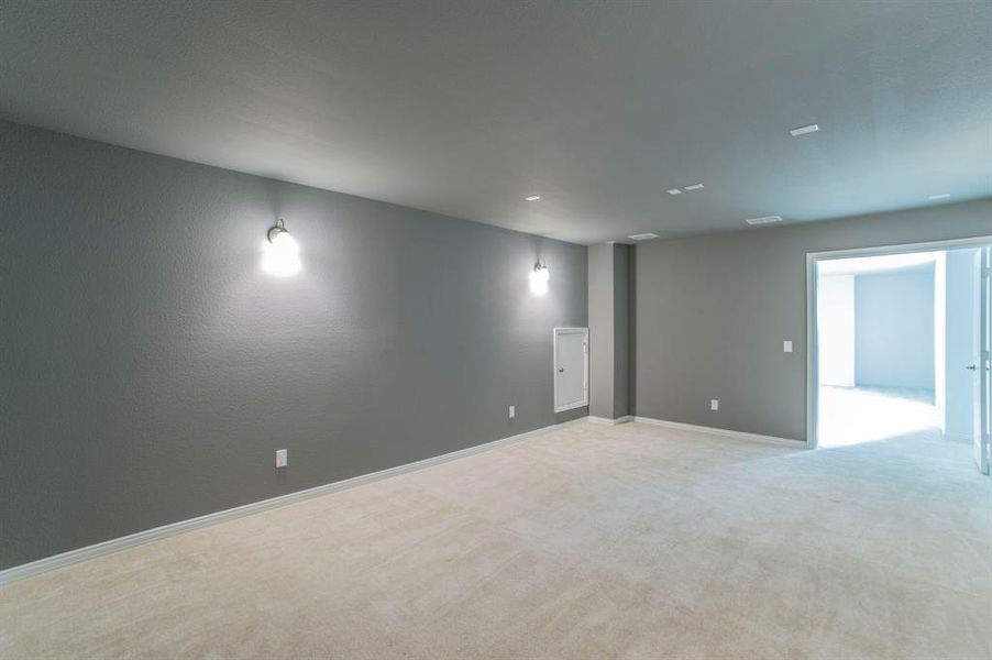 Spare room with light colored carpet and baseboards Spare room with light colored carpet and baseboards