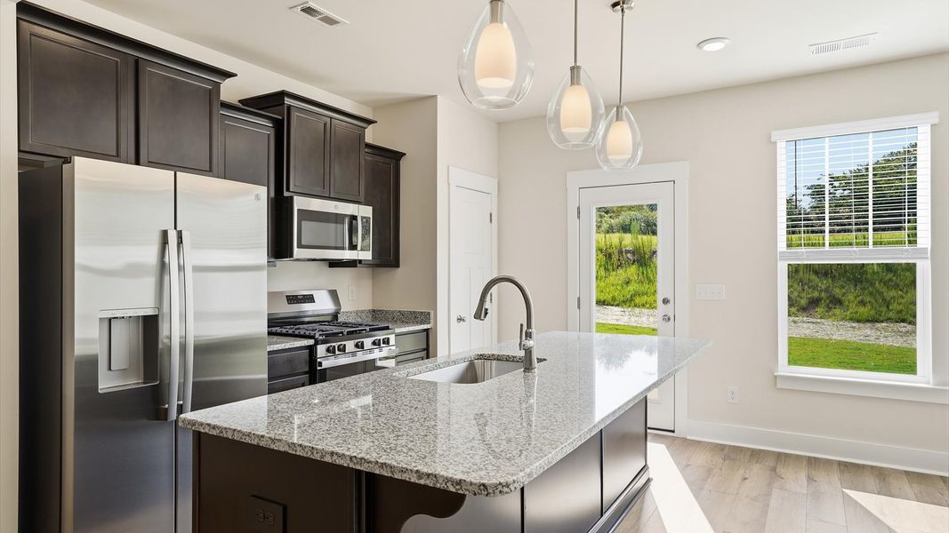 Memorable meals begin in this vibrant kitchen with pendant lighting and a thoughtfully designed island at Marion Square