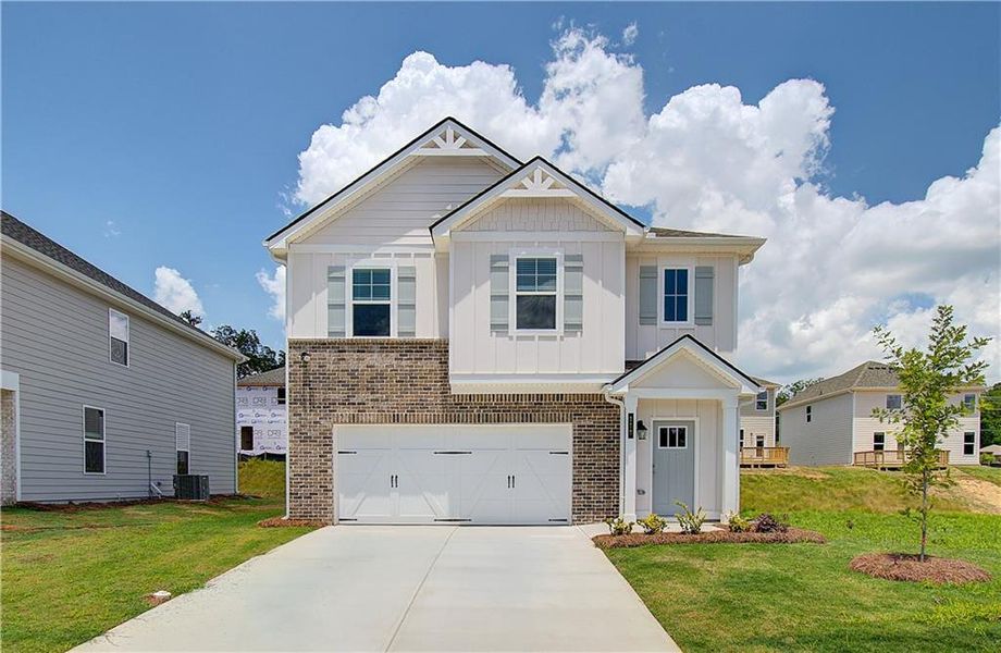 Front exterior of a new home in Enclave at Evergreen, Fairburn, GA, highlighting curb appeal (Image 16). Front exterior of a new home in Enclave at Evergreen, Fairburn, GA, highlighting curb appeal (Image 16).