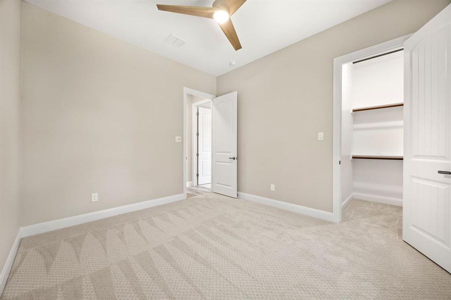 bedroom featuring ceiling fan, a closet, and light carpet