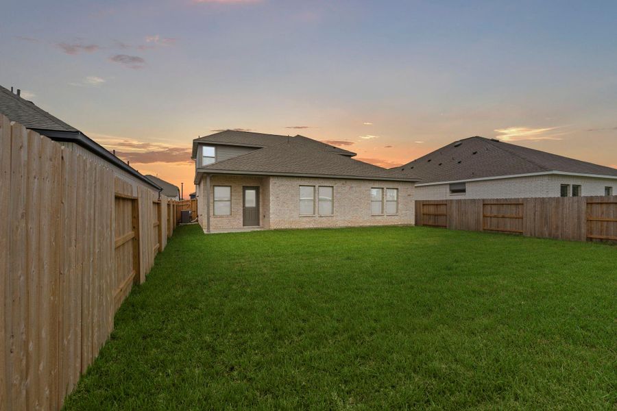 Exterior details and patio area of a home in Windrose Green, Angleton (Image 18).