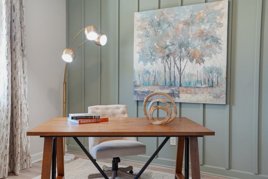 A table with a lamp and a painting on the wall. A table with a lamp and a painting on the wall.