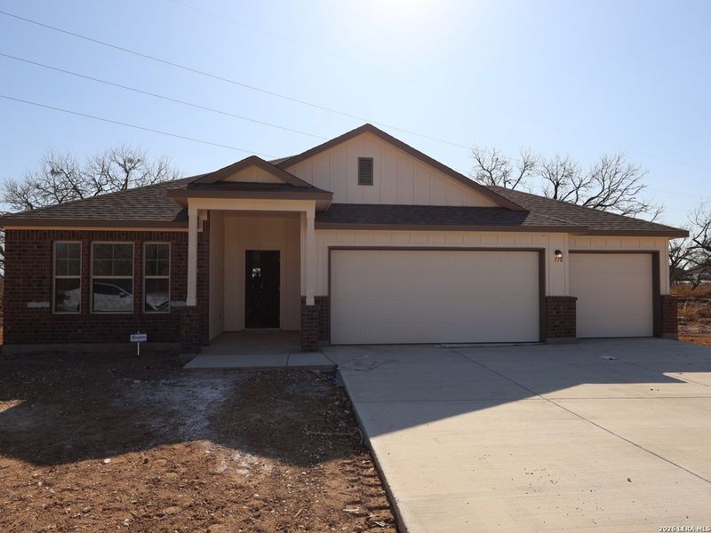 Front exterior of a new home in Jordan's Ranch, San Antonio, TX, highlighting curb appeal (Image 1). Front exterior of a new home in Jordan's Ranch, San Antonio, TX, highlighting curb appeal (Image 1).